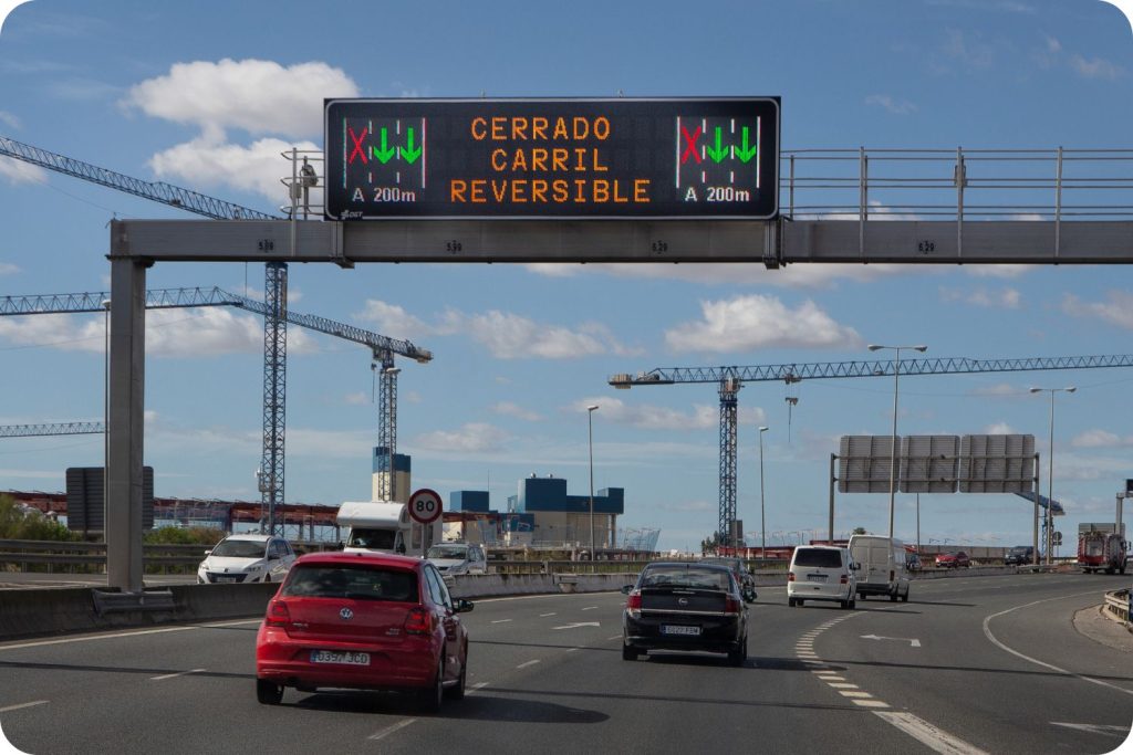 Panel informativo de tráfico con límite de velocidad de 90 km/h, aviso de velocidad controlada por radar y pictograma luminoso de vigilancia en carretera